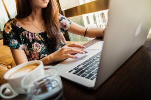 woman sat at a desk working on a laptop
