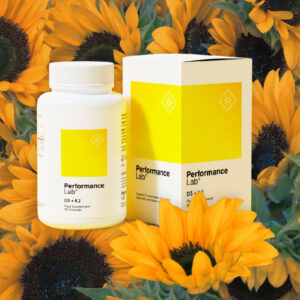 A bottle of Performance Lab D3 + K2 in a field of sunflowers