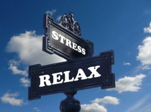 Two signs, one saying Stress and the other saying Relax, pointing in different directions