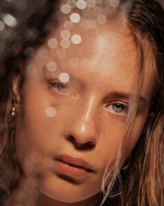 a woman looking at the camera with clean make-up free skin